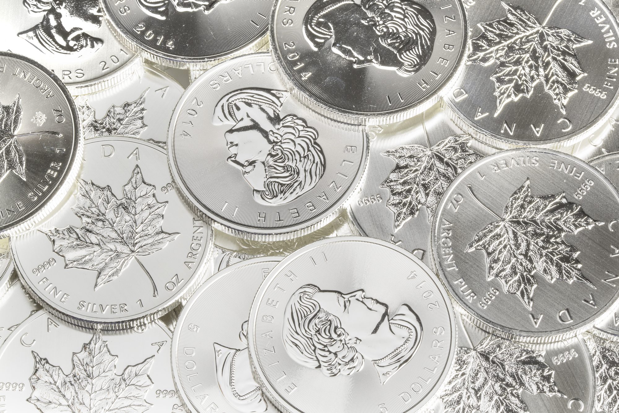 A pile of Canadian silver Maple Leaf bullion coins